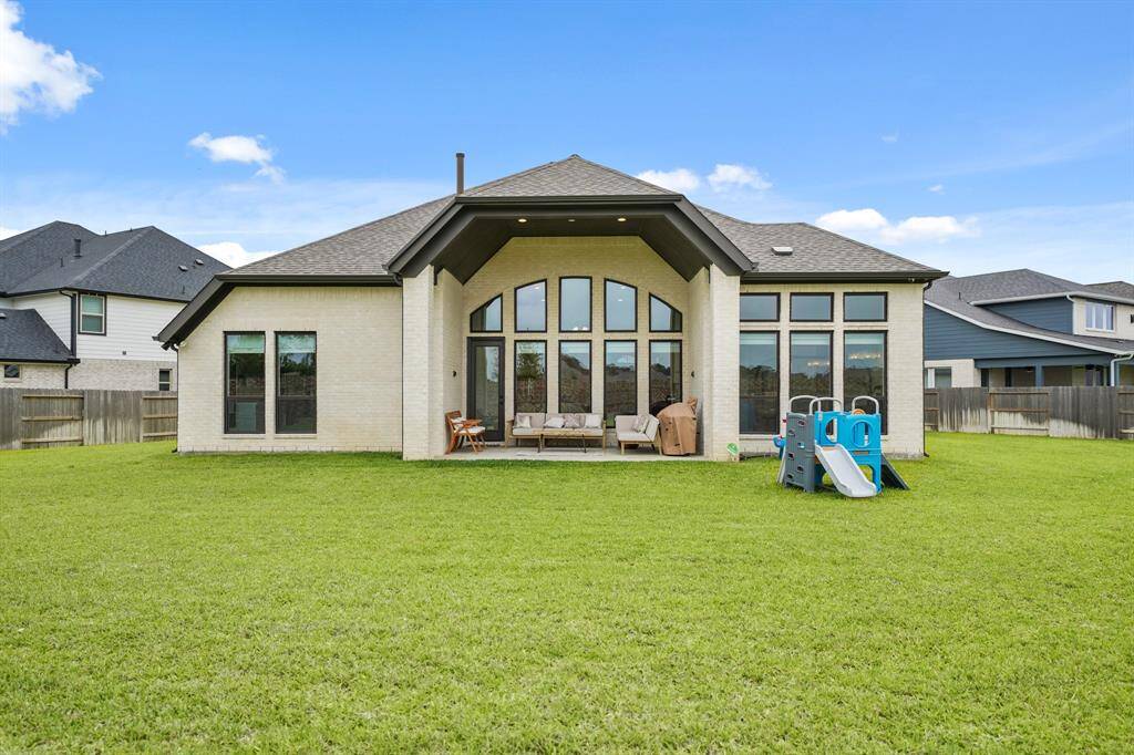 A charming Covered Patio anchors the backyard, creating a seamless blend of indoor comfort & outdoor enjoyment.