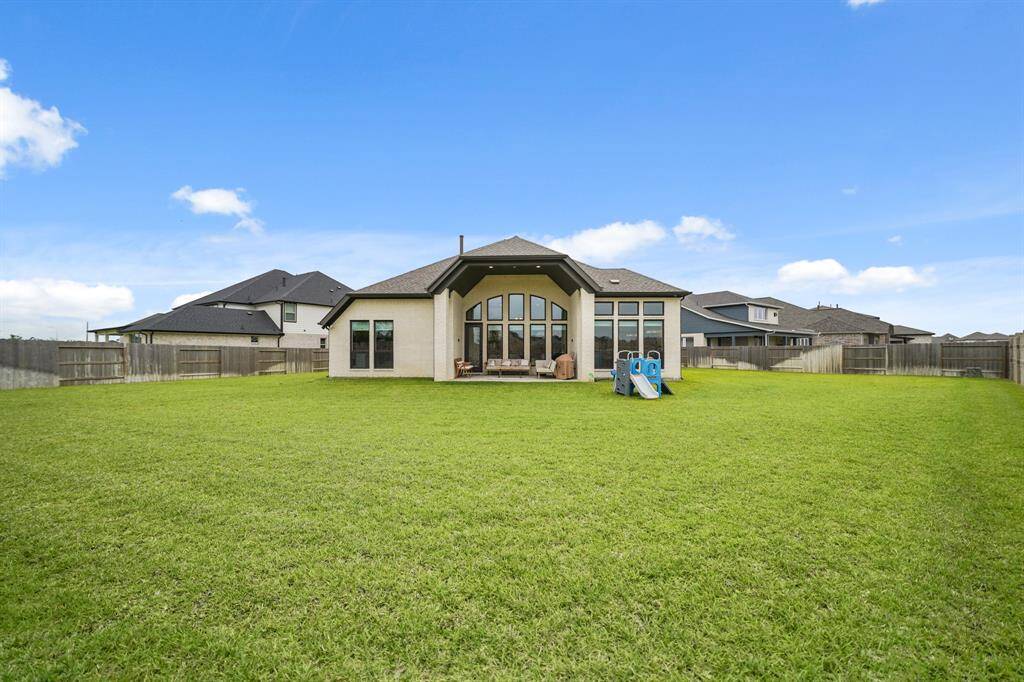 Enjoy outdoor living in this expansive backyard, complete with a 13 Zone Sprinkler System & plenty of space for a pool, playset, & more!