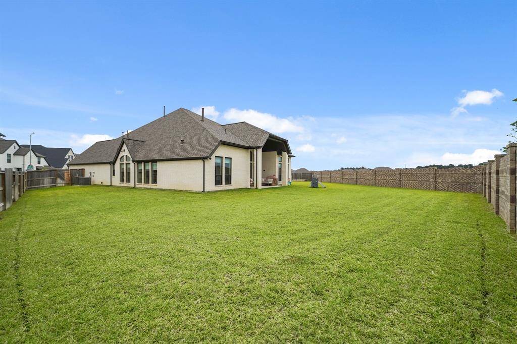 The oversized backyard offers privacy with no back neighbors, a covered patio, a Double Bulb Exterior Flood Light, & ample space for play, entertaining, or even a future pool.