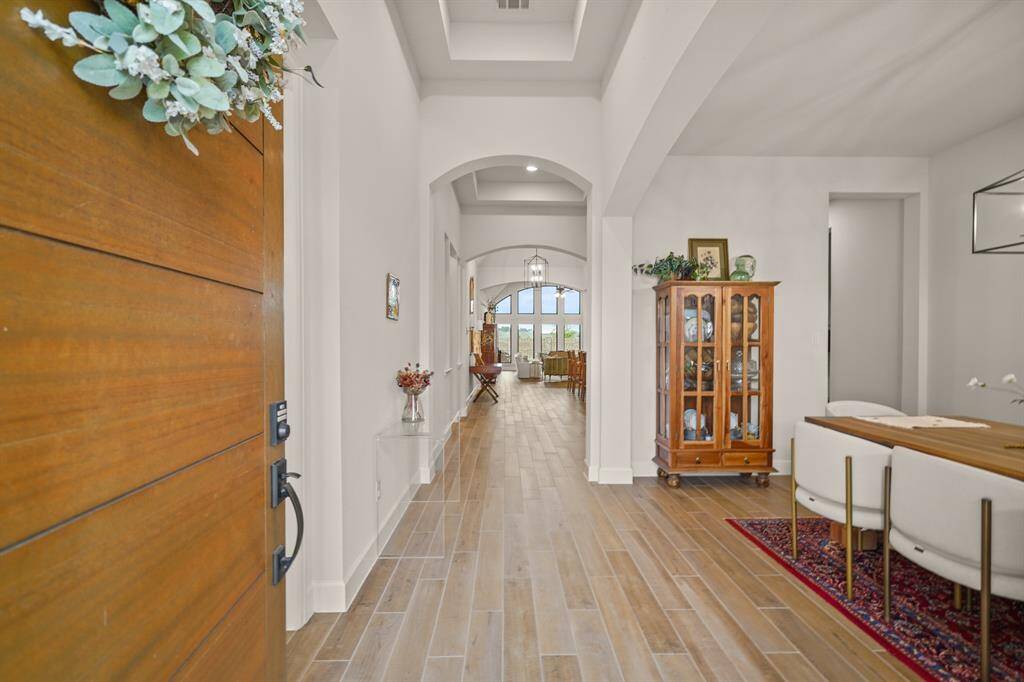 A striking first impression awaits you in this sleek, modern Entryway. Clean lines, wood-look tile flooring throughout with no carpet, tasteful lighting, & curated finishes create a look that’s as stylish as it is welcoming.