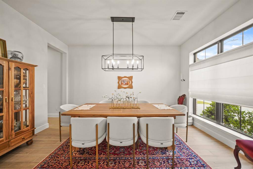 The Formal Dining Room offers refined finishes, ample seating, & a Perryton Midnight Black Chandelier — perfect for elegant dinners & special occasions.
