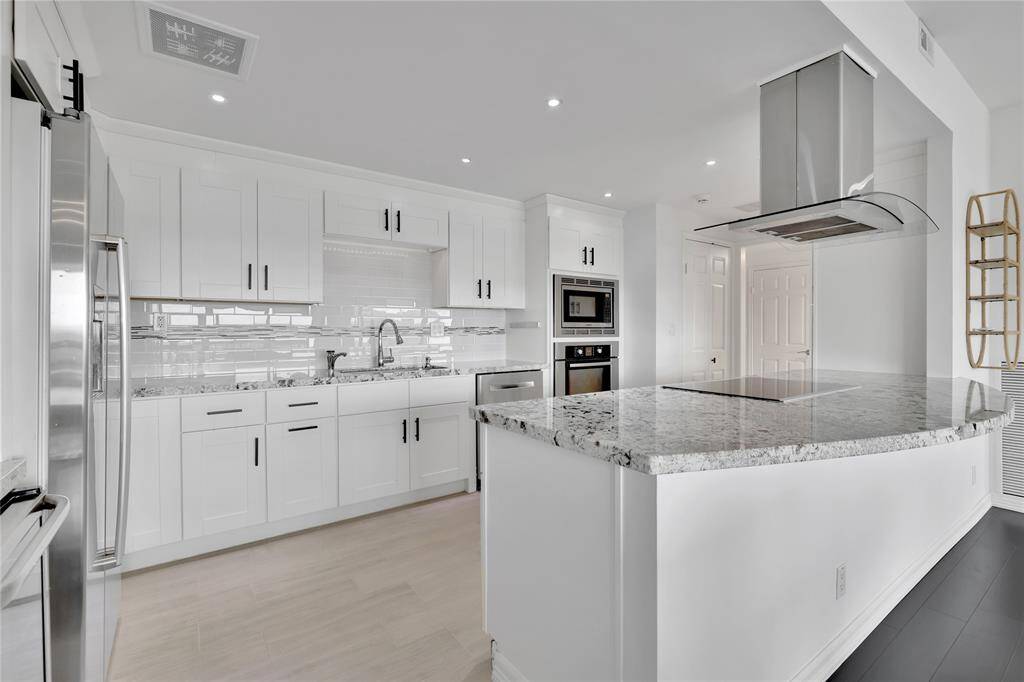 The kitchen has a bar area that could accommodate additional seating.