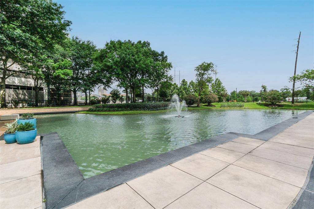 The walkway behind the pond leads to Braes Bayou walking and jogging trail.