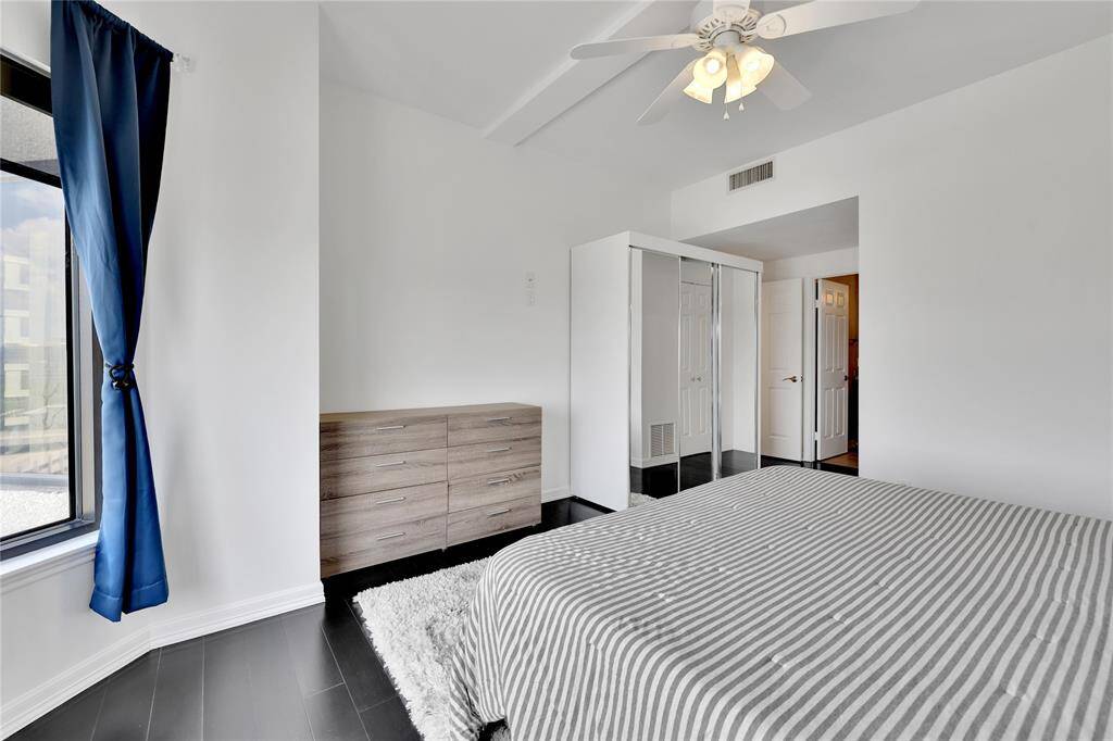 Another look in the primary bedroom toward the 8-drawer dresser and separate sliding door wardrobe. There's plenty ofspace to keep your clothing neatly organized.