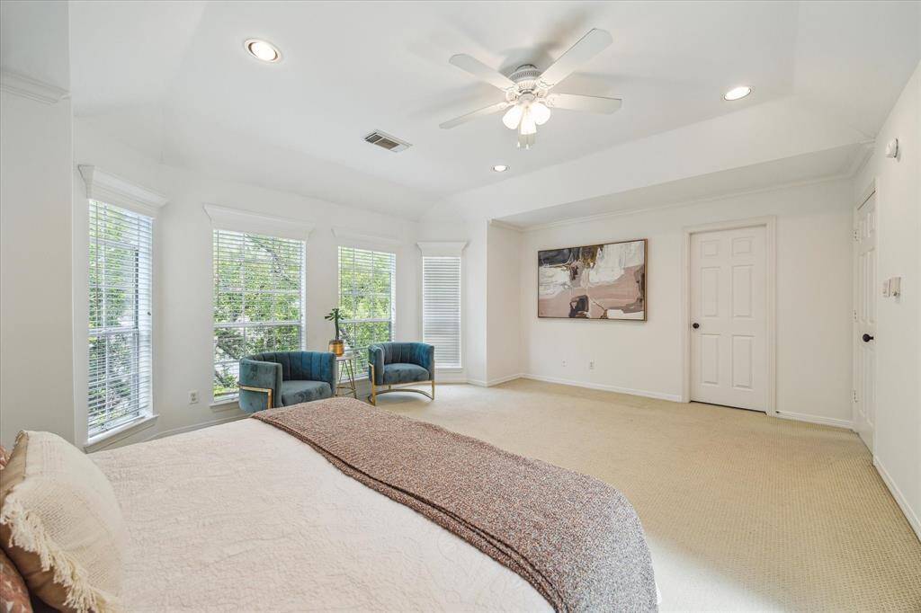This alternate angle of the primary bedroom highlights its expansive layout and natural light. Clean lines and soft tones create an airy ambiance ideal for relaxation and unwinding.