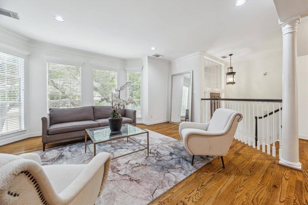 Upstairs, enjoy abundant natural light and treetop views of a majestic live oak from the spacious living room.