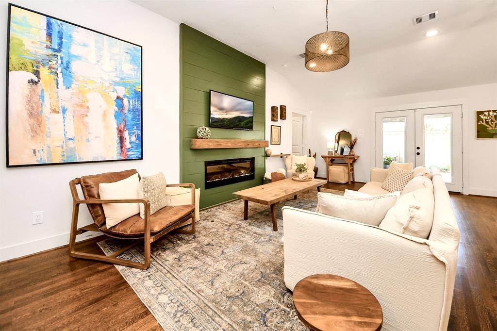 Inviting family room with vaulted ceilings and a sleek electric fireplace.