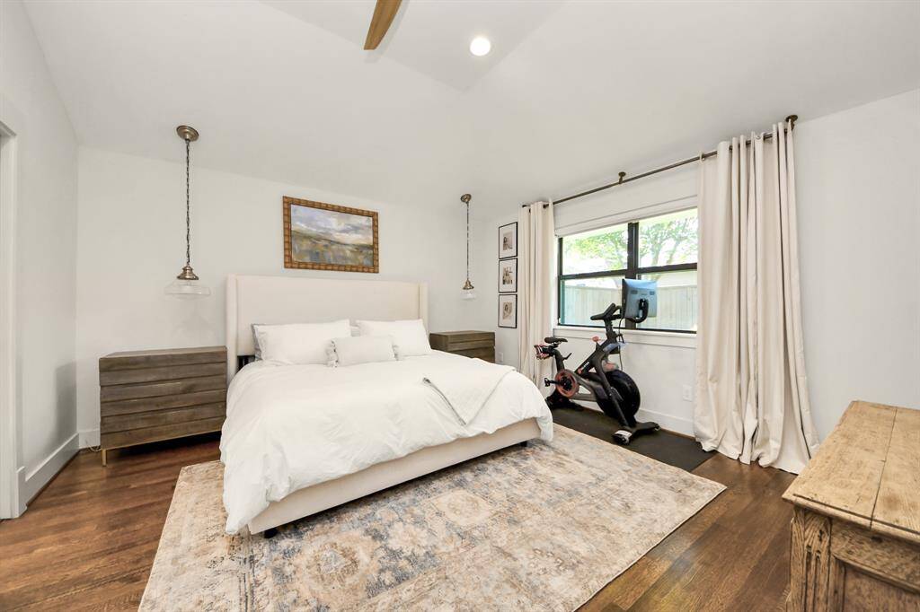 Primary suite with beautiful hardwood floors and high ceilings.
