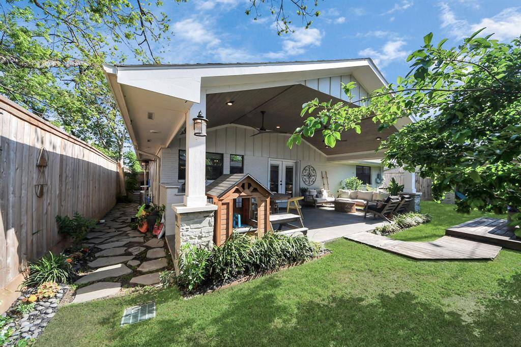 Discover a serene backyard oasis with a spacious 2019 covered patio, perfect for relaxing and entertaining. Enjoy lush greenery, a pathway to the relaxing hot tub, and added comforts like a mosquito misting system, sprinkler system, and French drains for easy maintenance.