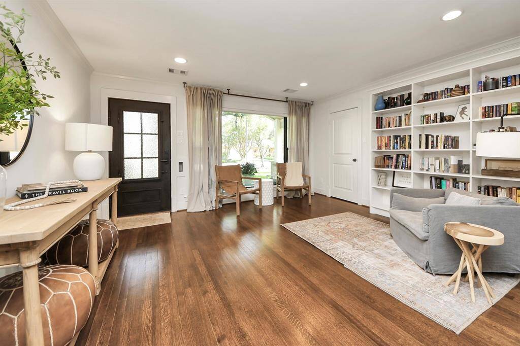Elegant living room with built-in shelves and a convenient entry closet, perfect for a home office or formal living room.