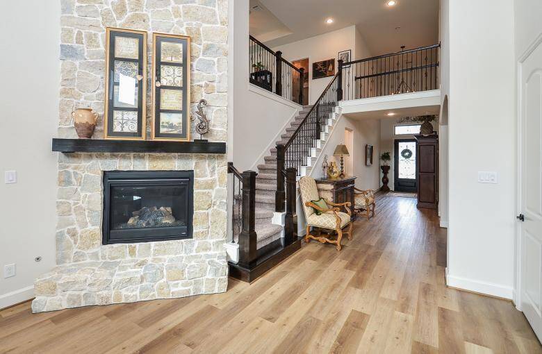 This Grand Family Room is the Heart of the Home, where a Stately Fireplace Creates the Ultimate Focal Point and Conversation Piece.