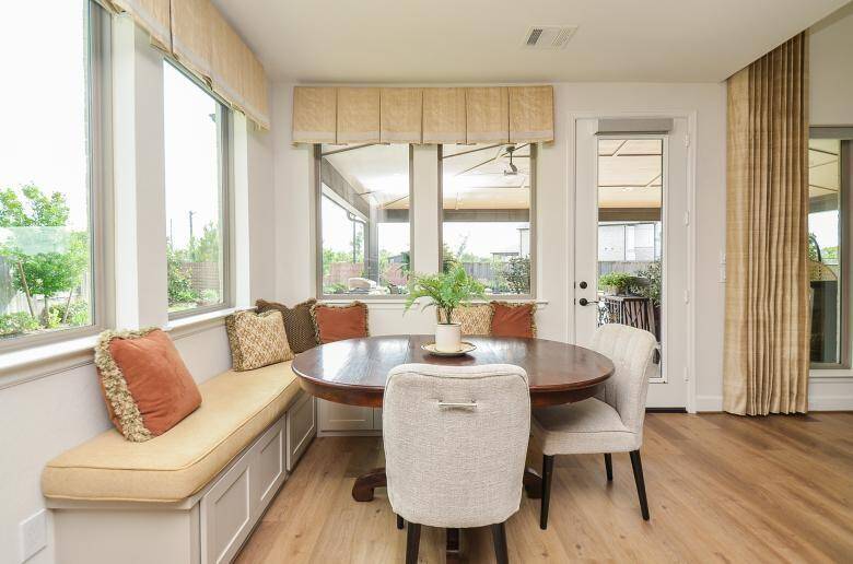 The Breakfast Area is Surrounded by Large Windows and is Conveniently Located Next to the Kitchen.