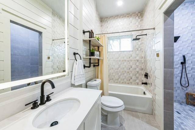 Guest bath has a walk-in shower along with a tub/shower unit