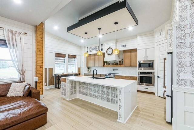 Waterfall countertop on island with custom tile work and custom wall features