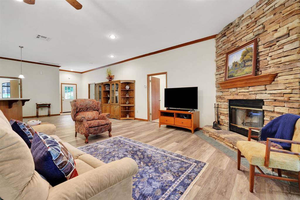 The living area has a wood burning fireplace with stone surround