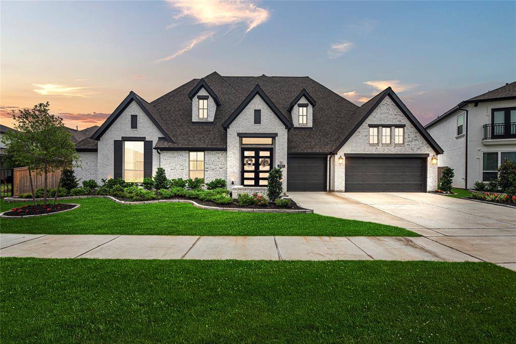 Welcome to your dream come true home! A sprawling one story home on a huge lot with no rear neighbors. This striking elevation greets you with the white washed brick, high contrast trim and 3 car across garage.