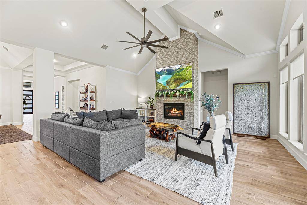 This chef-inspired kitchen impresses with soaring vaulted ceilings, an abundance of custom cabinetry, and sleek  appliances - double ovens!
