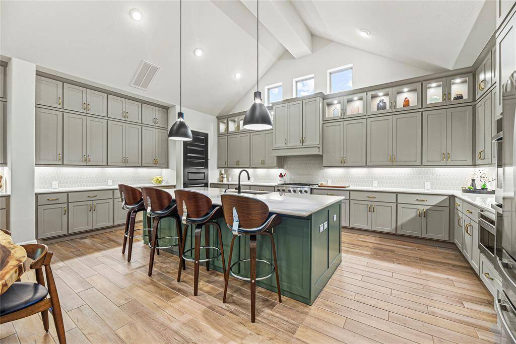 Thoughtful lighting and expansive counter space create a bright, functional, and luxurious culinary space.