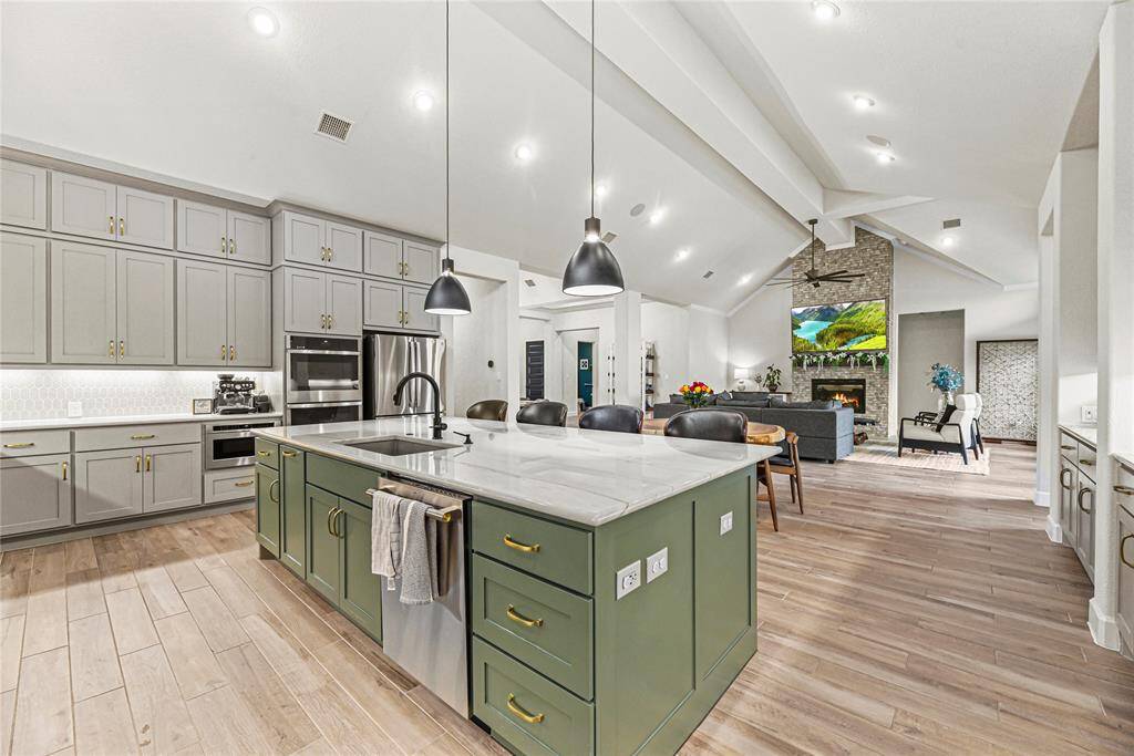 This impressive kitchen also features a large pantry and pull out trash cabinet.