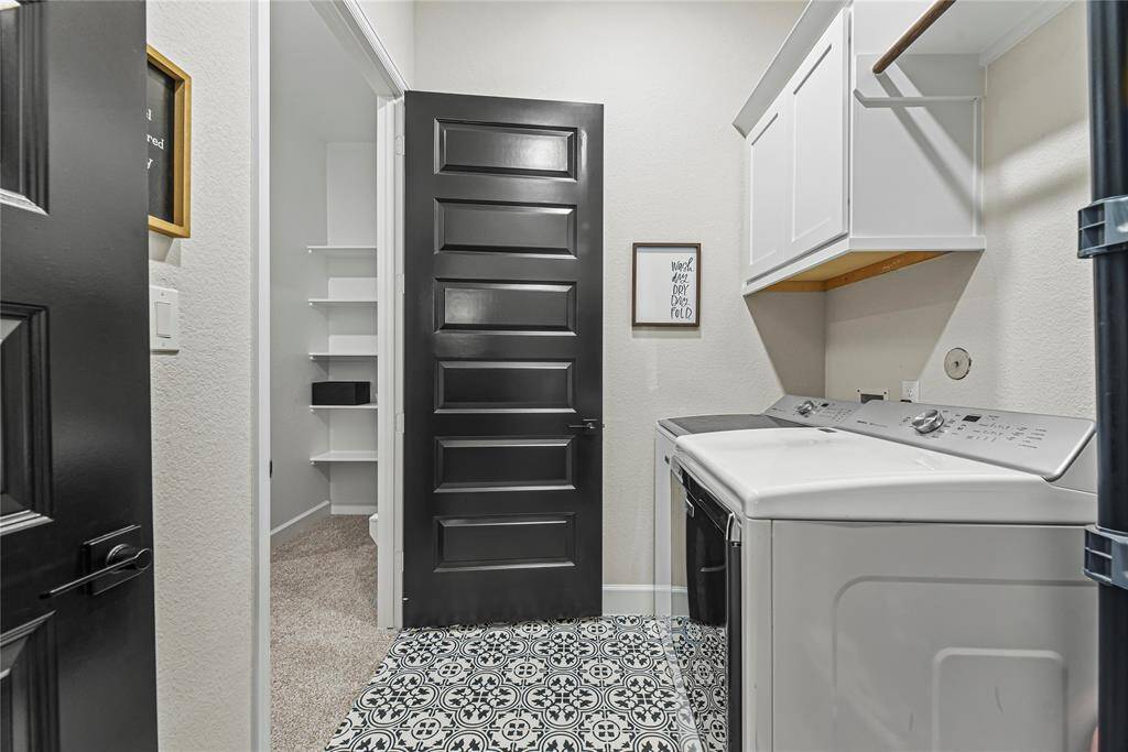 Generously sized laundry room connects directly to the primary closet and hallway for easy access.
