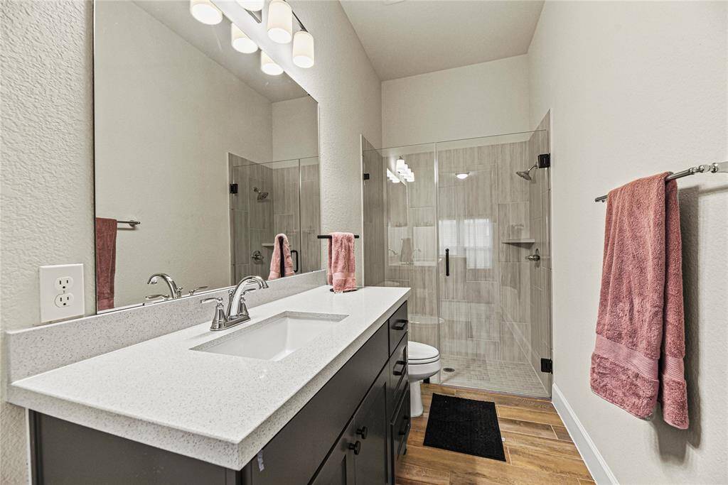 Ensuite bath with plenty of counter space and a sleek walk-in shower.