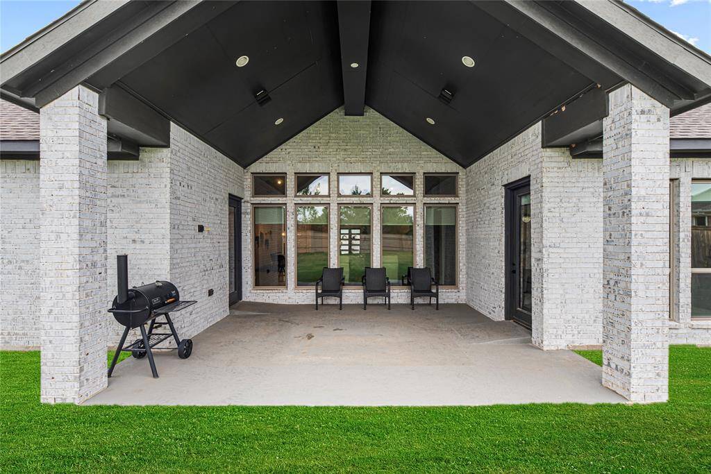 Large covered patio with soaring vaulted ceilings and recessed lighting, perfect for year-round outdoor living and entertaining.