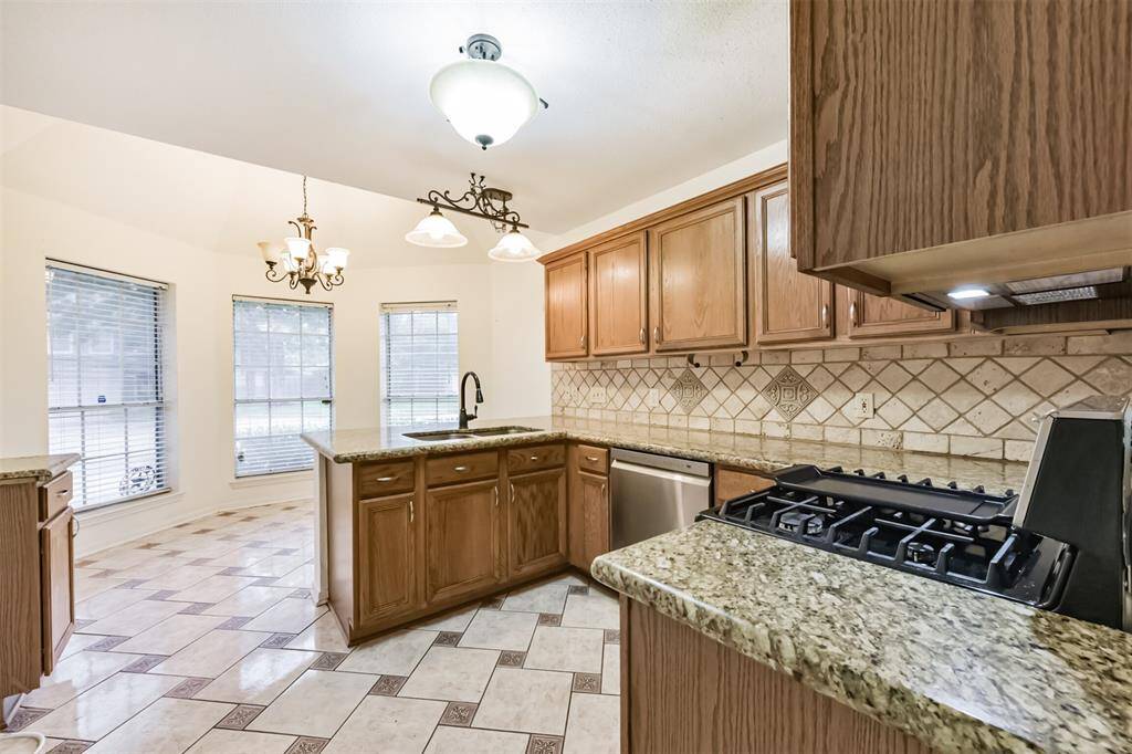Sleek tile backsplash adds texture and charm to this heart-of-the-home space.