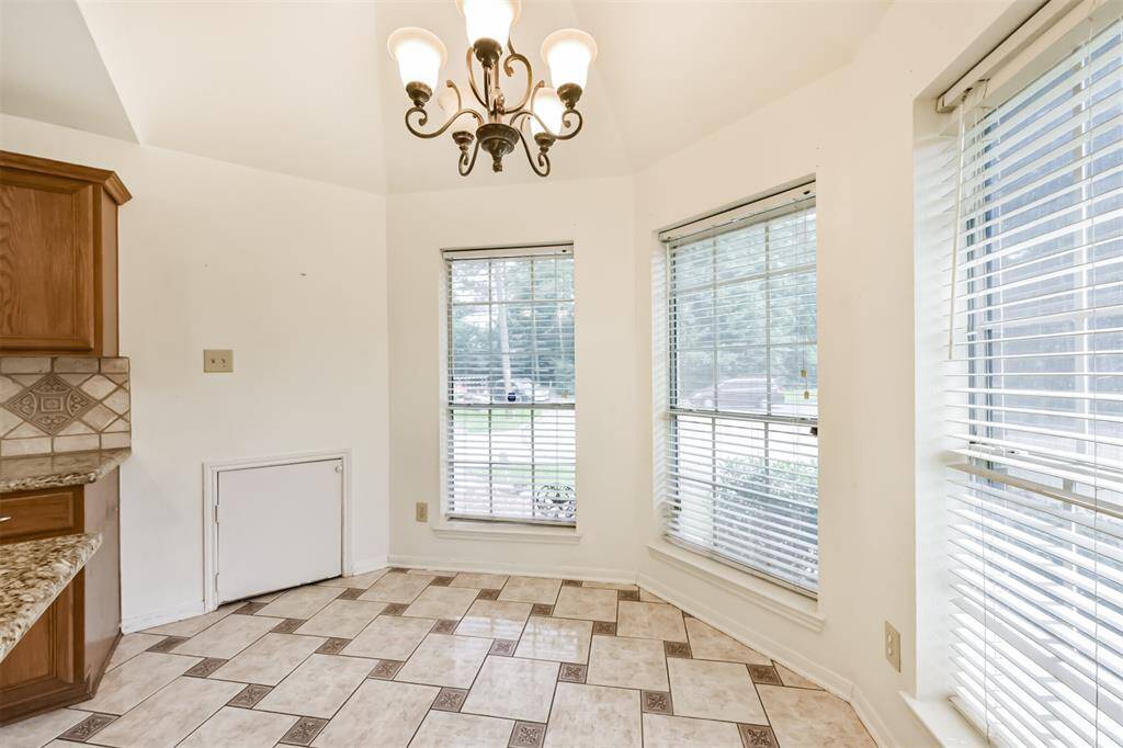 A curved dining area with a chandelier offers the perfect morning glow.