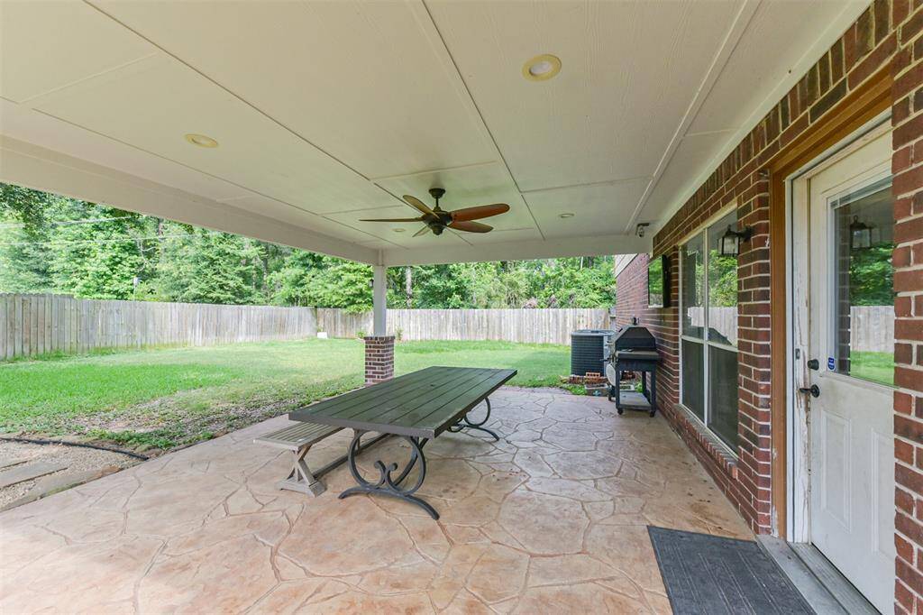 Mature trees offer natural beauty and privacy in this spacious backyard oasis.