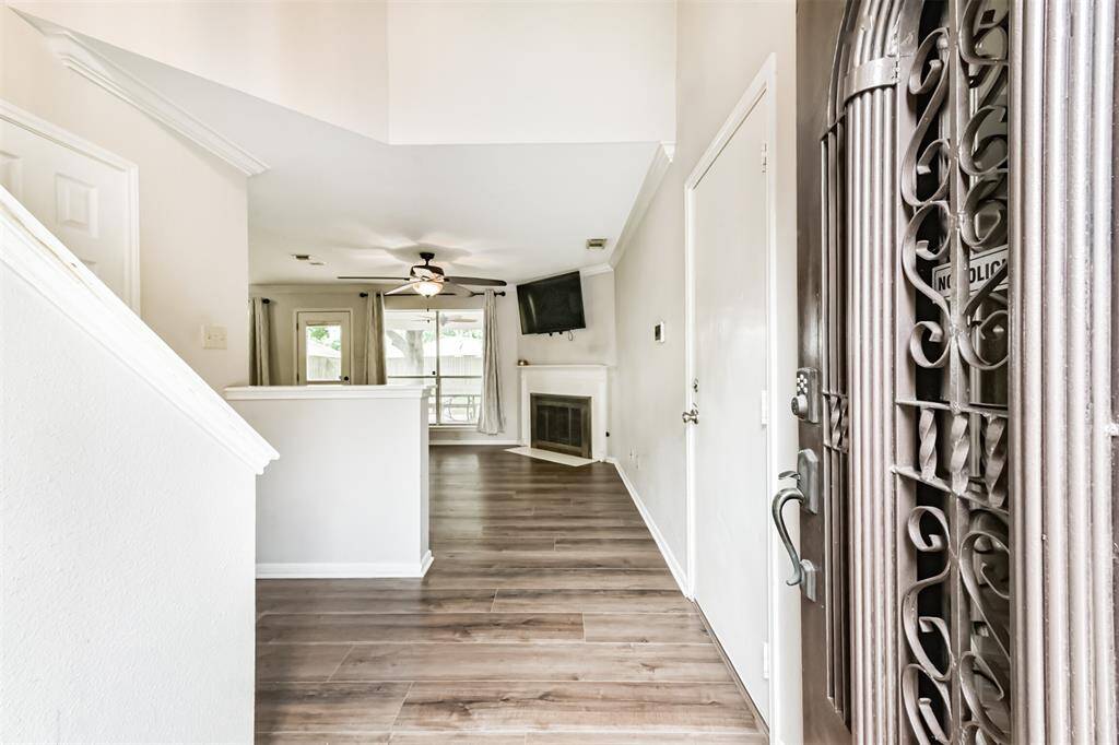 A stately wooden door featuring elegant beveled glass welcomes you home.