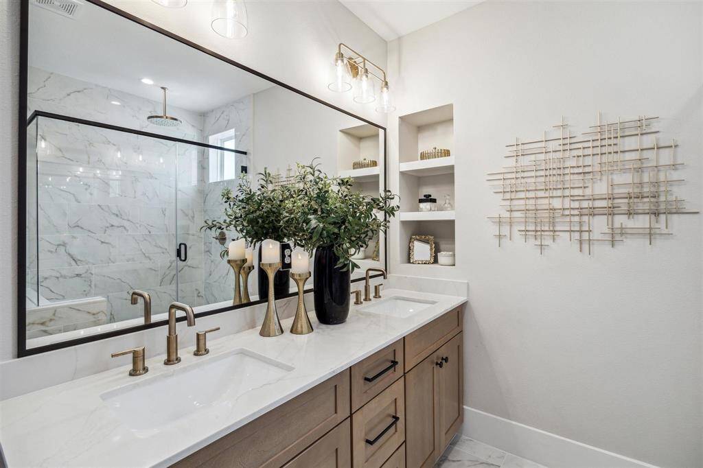 Primary features spa-like bathroom with dual sinks, large soak-in tub and spacious walk-in shower
