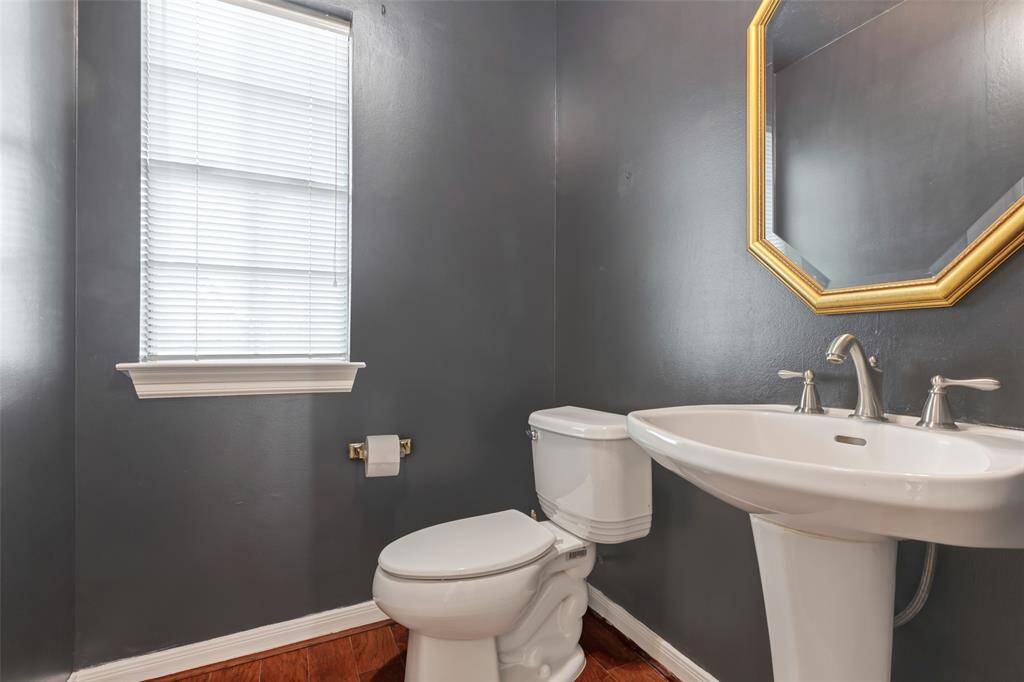 A modern paint scheme is featured in the powder room conveniently located for guests.