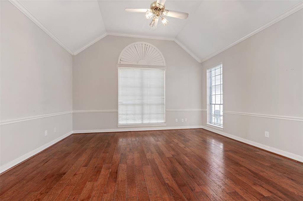 Bring your bold bedroom furniture arrangement. This spacious primary can certainly accommodate large pieces. Trimmed in crown moulding, chair rail and palladium window, sweet dreams come easily.