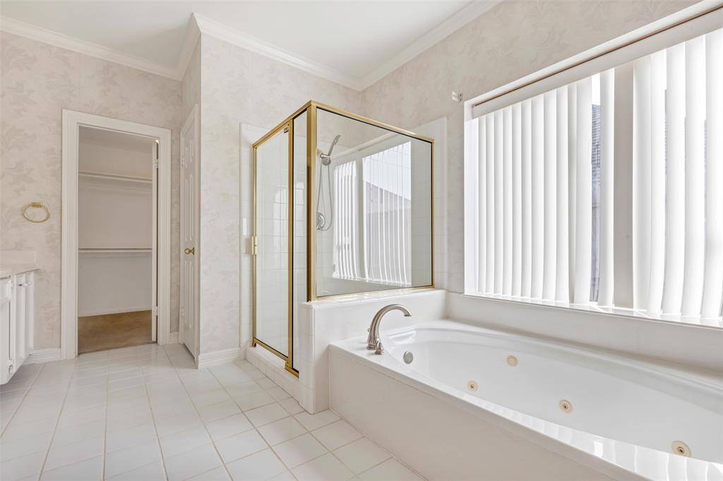 The spa-like primary bath includes a jetted tub and extended glass surround shower. Your choice - bubbles and a book or a steamy relaxing shower?