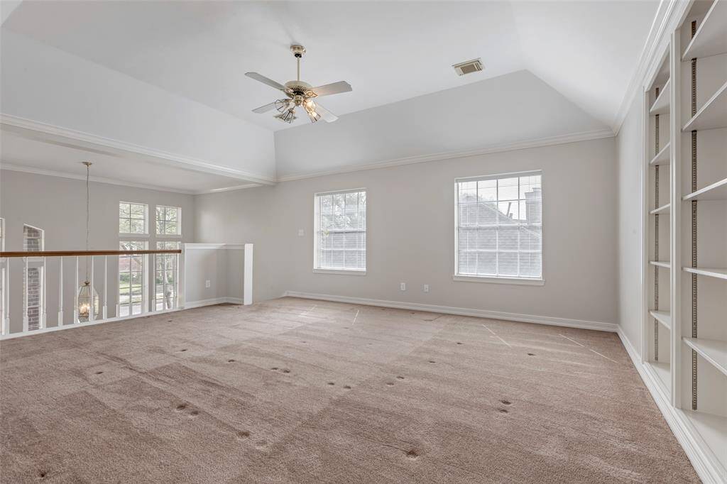 The upstairs game room with built-in shelving is versatile depending upon your needs. It can be a playroom for littles, a game room for everyone, homework or office space. Not shown in the photo is an expansive storage closet.