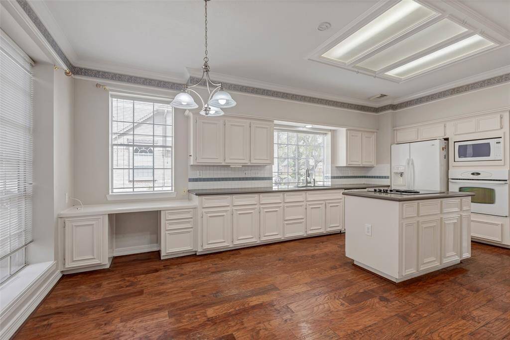 This spectacular kitchen is filled with abundant cabinetry, working desk, Corian countertops and tile back splash. The refrigerator is included.