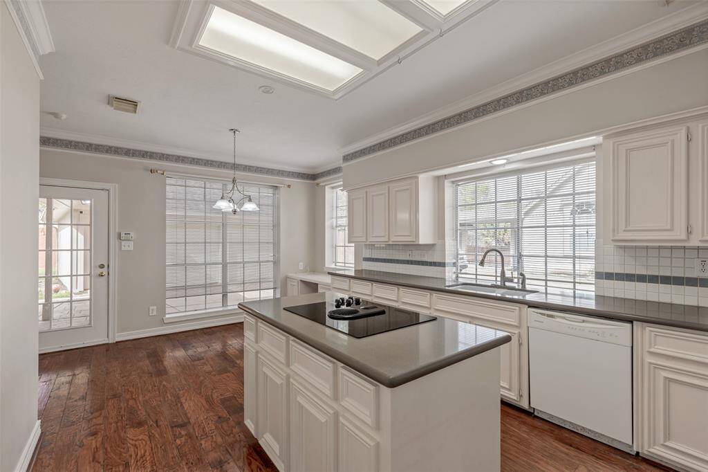Imagine the meals prepared at the kitchen island with electric cooktop and served at the kitchen table. With plenty of counterspace, there's room for many hands to help.