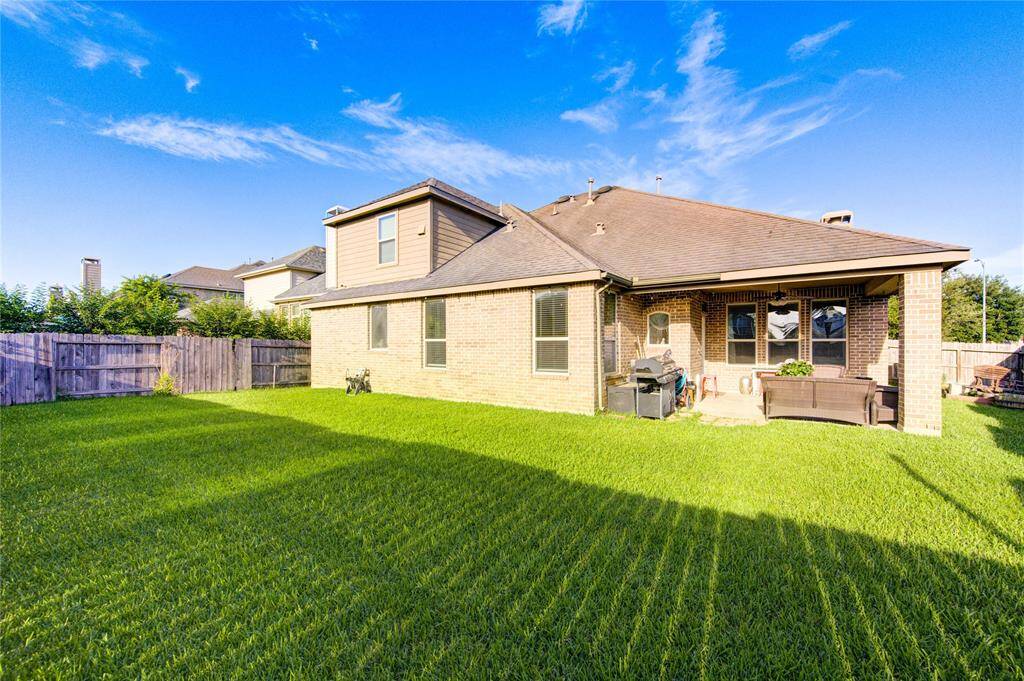 Charming brick home with a spacious, well-maintained backyard. Features a covered patio perfect for outdoor relaxation.