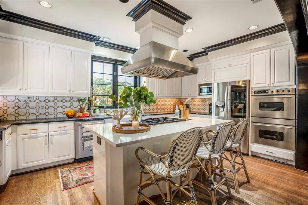 Quartz and soapstone countertops, high-end appliances, and custom spice drawers make cooking a delight.