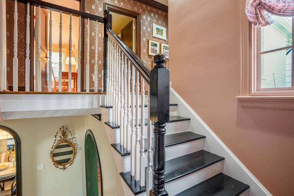 The custom window treatment compliments the stairway, creating an elegant transition to the upper level.
