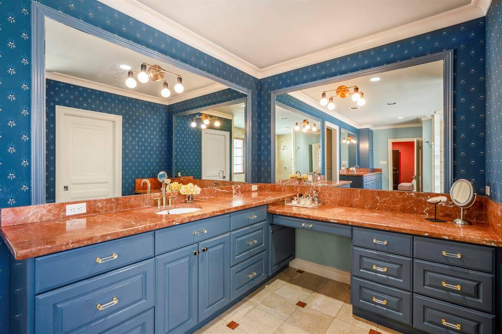 The primary bathroom offers both luxury and functionality with two separate sinks and an expansive vanity providing ample counter space.
