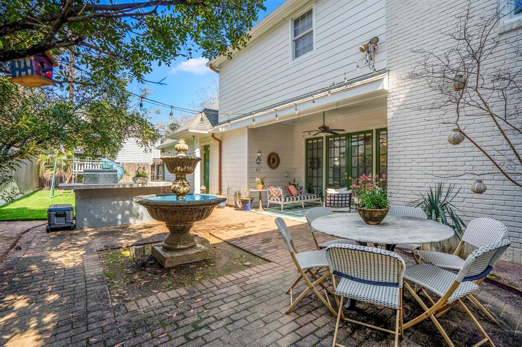 With lush greenery and a charming patio, this outdoor space invites you to relax and unwind. Picture summer evenings by the tranquil fountain or hosting under the twinkling patio lights.