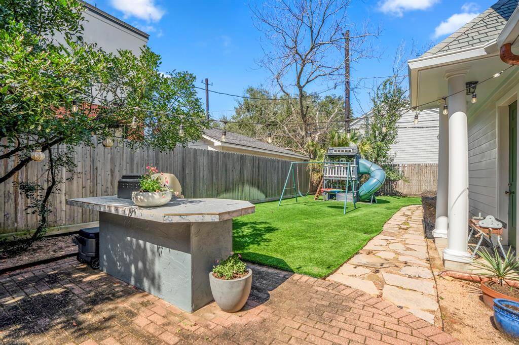 The turfed backyard offers endless possibilities for play, relaxation, and alfresco gatherings.