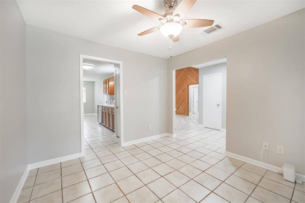 Formal dining/office at front of the home. The door to the right is a coat closet at the entry.