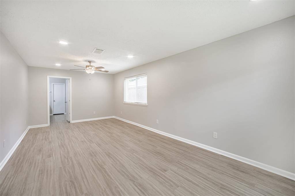 Primary bedroom features luxury vinyl plank flooring, fresh paint - and newly installed recessed lighting.