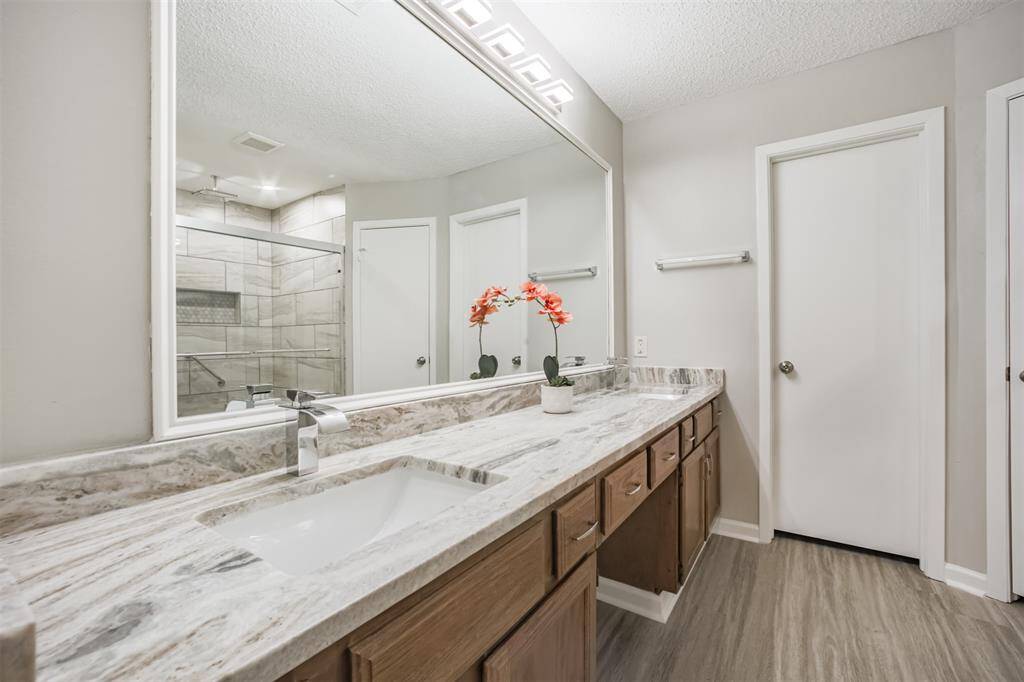 Primary bath beautifully updated. Gorgeous granite with double sinks! Updated faucets and lighting!