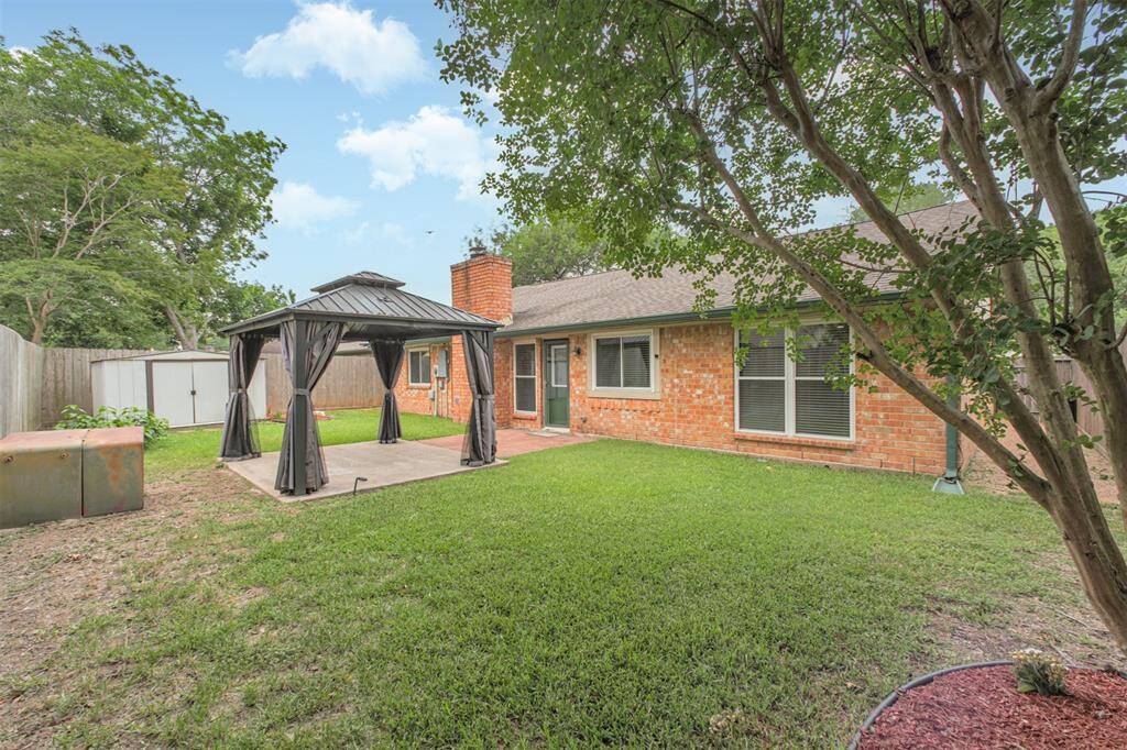 Spacious backyard with extended patio area and metal roof pergola! Side panels on pergola allow you to keep the bugs away!