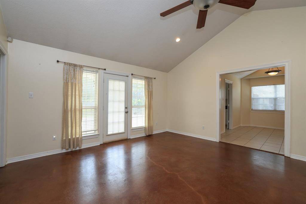 The breakfast nook is conveniently located off the kitchen and features large windows for natural light. The open layout and vaulted ceiling enhance the airy feel.
