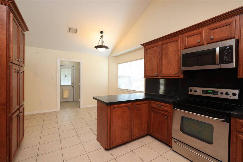 Utility room has a place for a freezer or extra refrigerator.