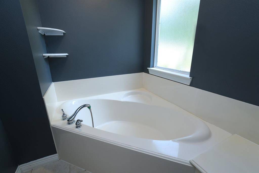 One of the secondary bedrooms, complete with chair rail, accent wall, and a darling light fixture.
